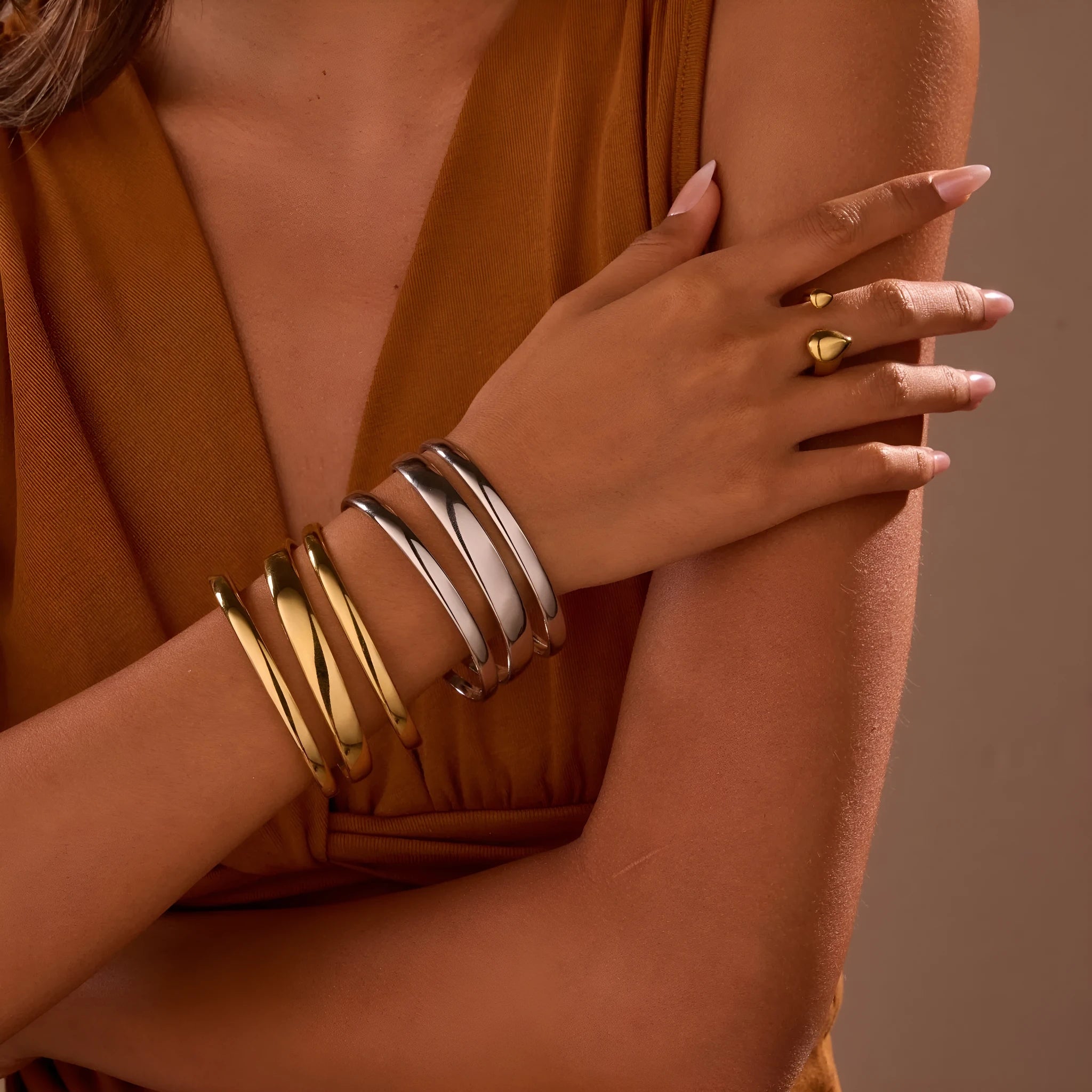 Geometric line design stainless steel bracelet with simple opening clasp, shown in gold and steel colour options.