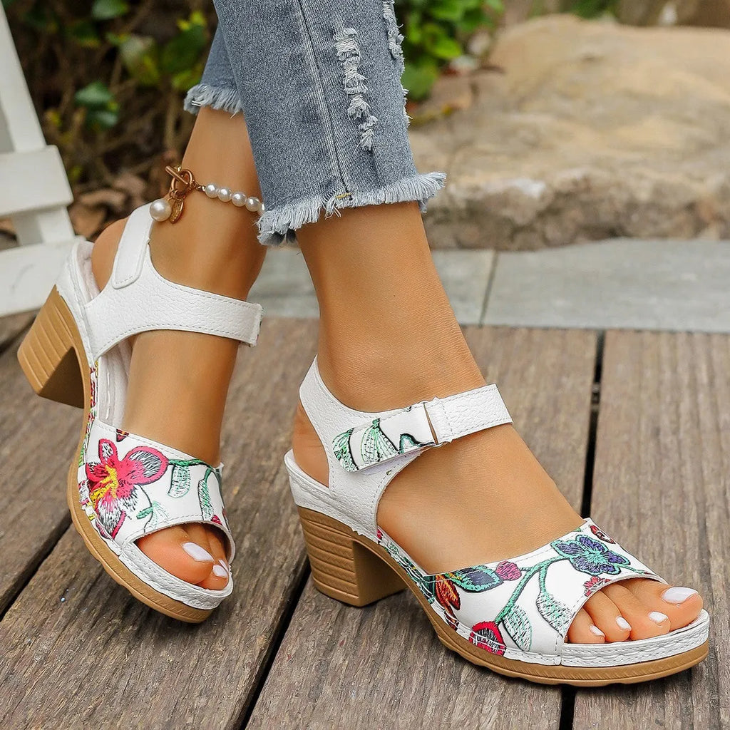 White women's high heel sandals with a Velcro strap buckle on the ankle.