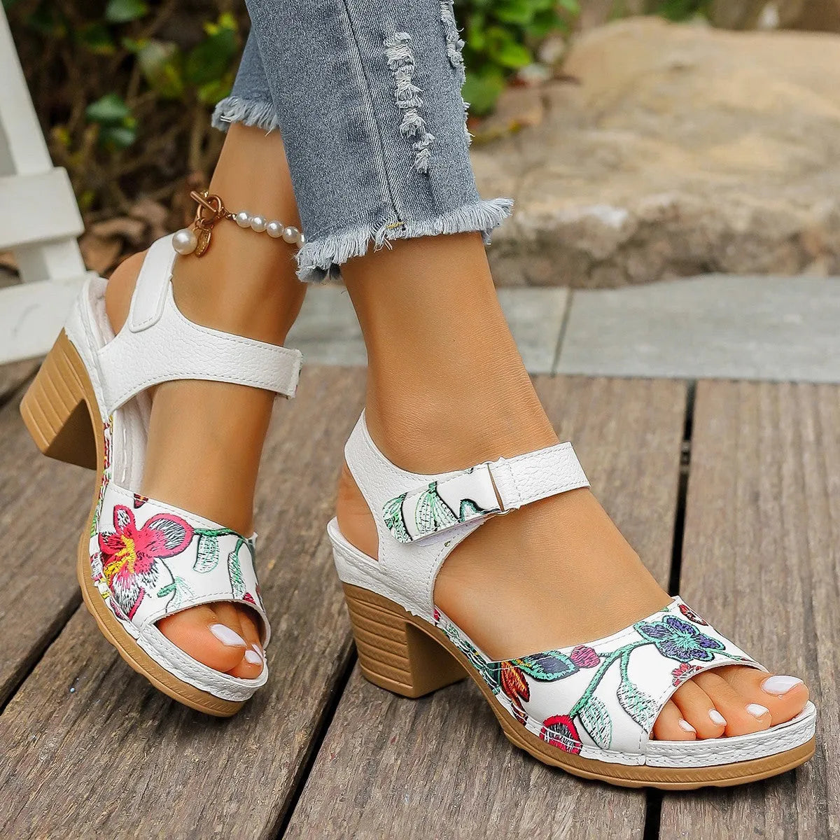 White women's high heel sandals with a Velcro strap buckle on the ankle.