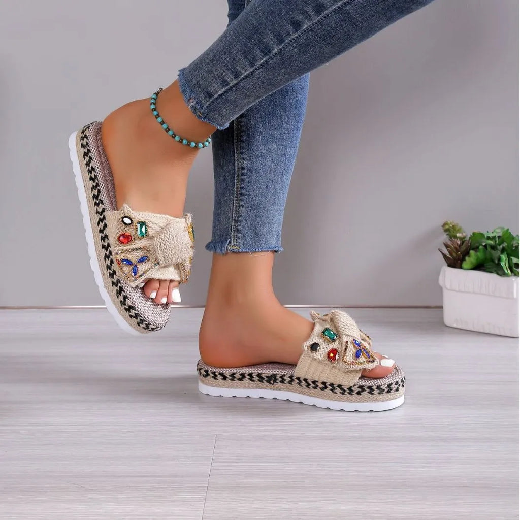 Creamy-white women's platform sandals with a cloth upper, round toe, and a decorative beach bow.