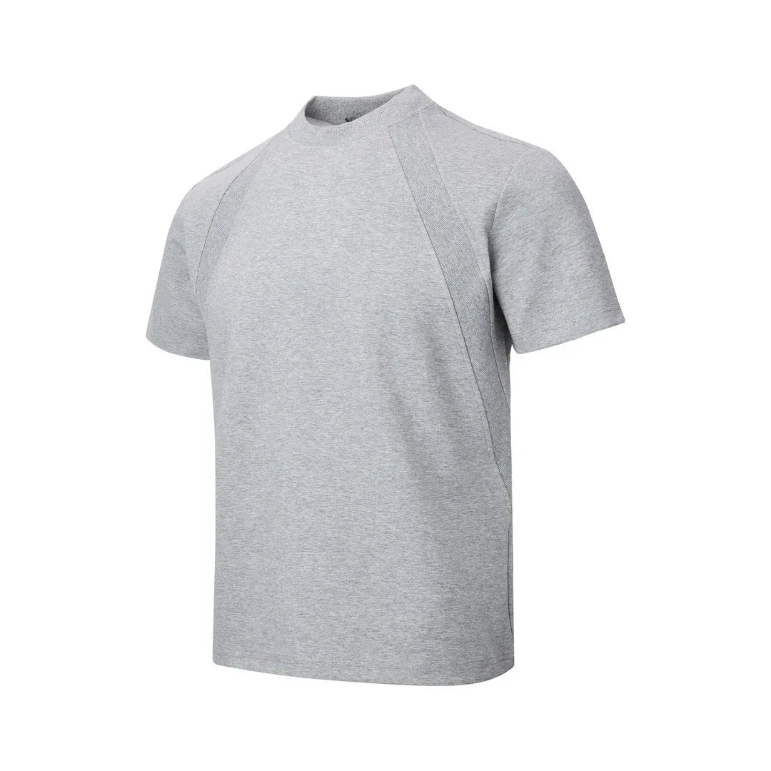Men's loose fit short sleeve top in black with air layer stitching detail on a grey background.