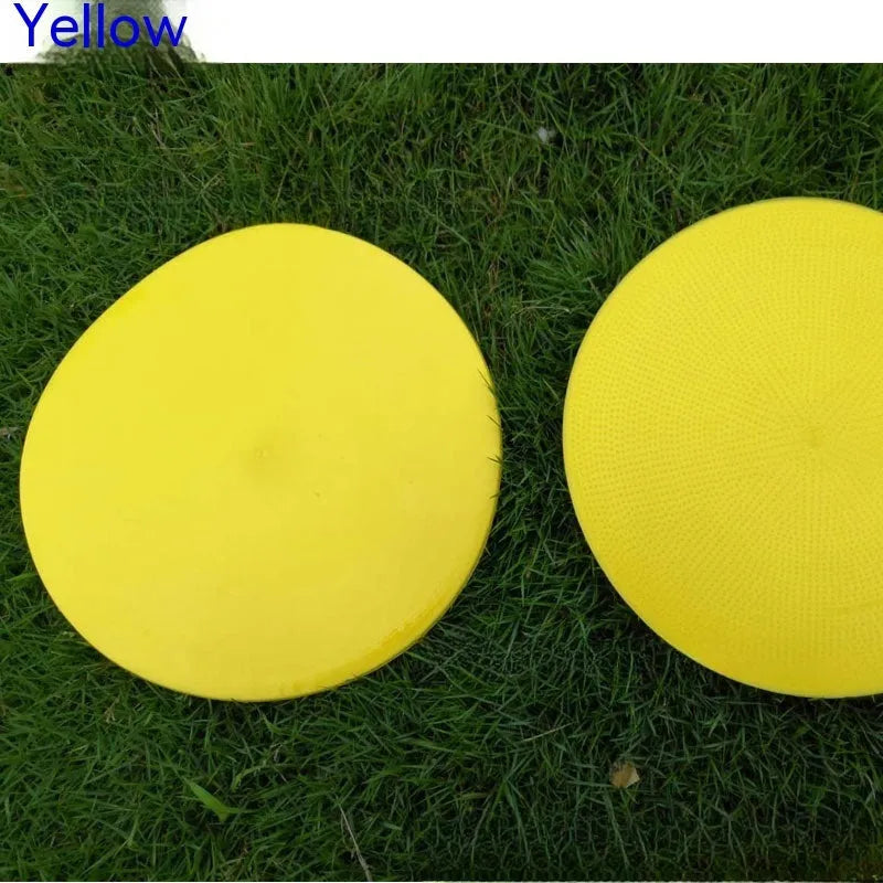 Yellow football training marker disc on grass field showing 23cm diameter flat design