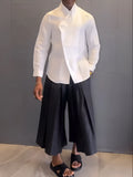 Women's white asymmetrical front long sleeve shirt with black pleated trousers casual set