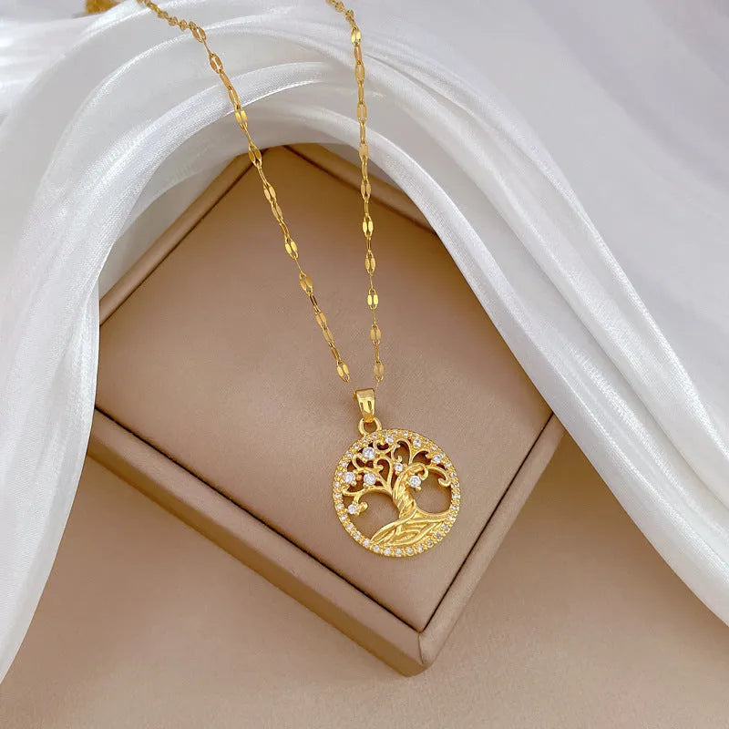 Gold-plated necklace with mother pearl shellfish pendant and rhinestone lucky tree design on an adjustable chain.