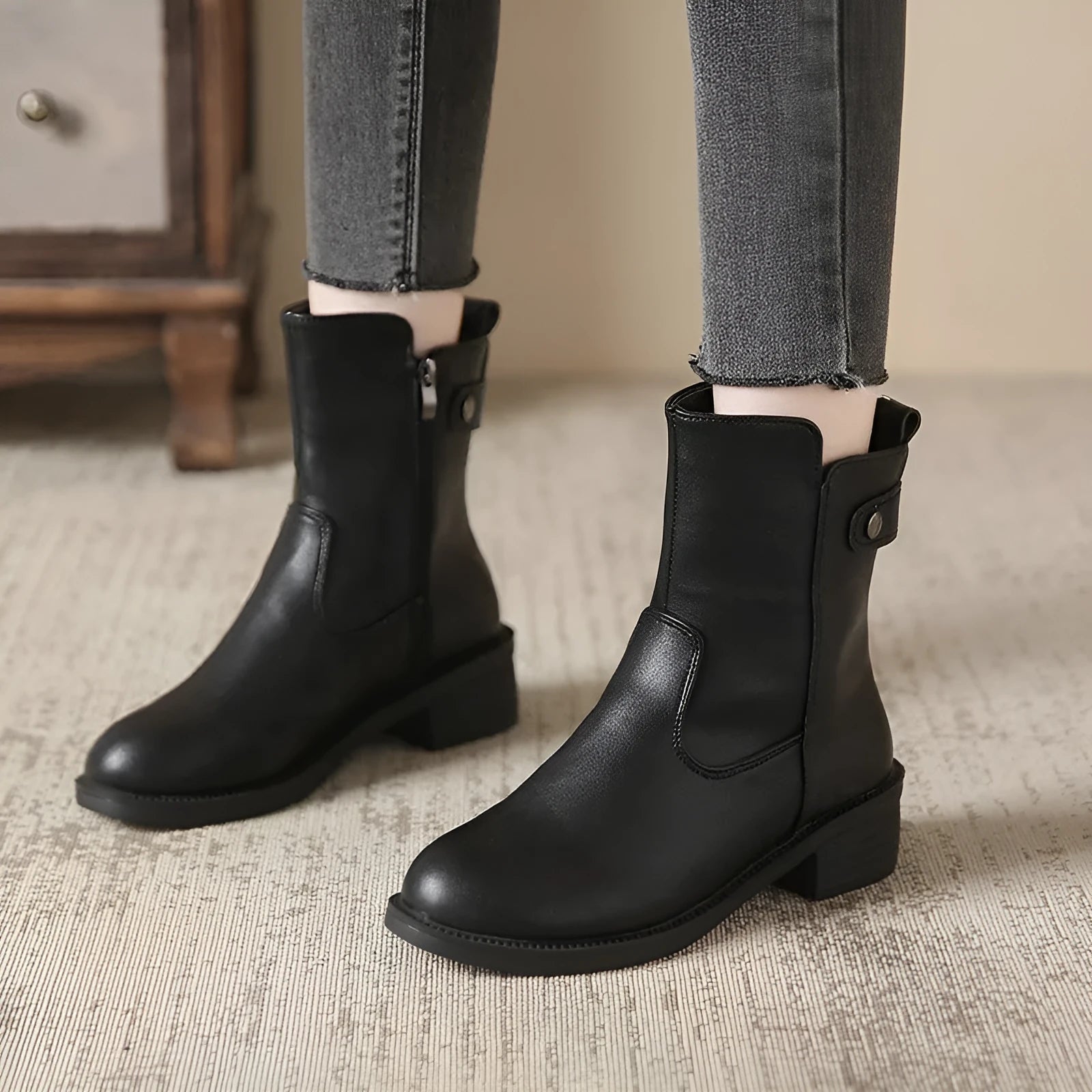 Women's black low heel round toe side zip ankle boots showing front and side views