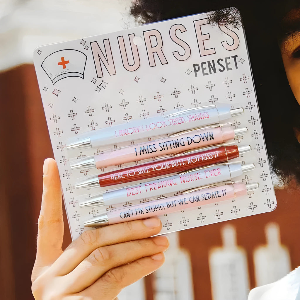Five nurse-themed retractable ballpoint pens with humorous medical prints arranged together