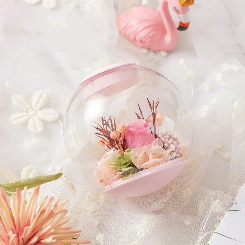 Pink preserved rose ornament with LED lights on a base, with optional audio Bluetooth for music.