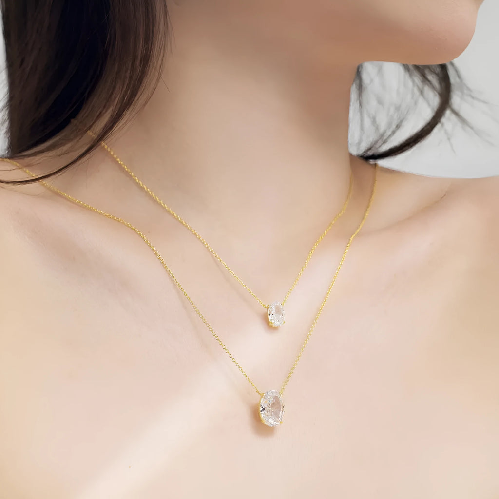 Close-up of a women's sterling silver necklace with a geometric oval ice flower pendant.