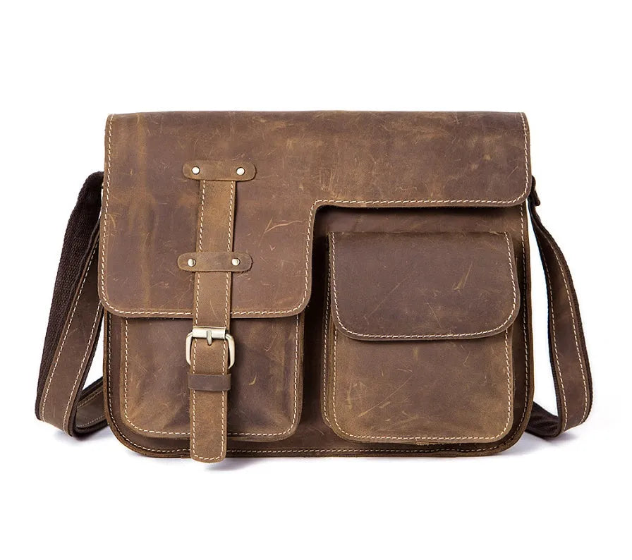 Brown full-grain leather vintage messenger bag with brass hardware, showing front flap and adjustable crossbody strap.