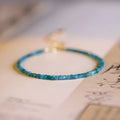 Women's blue apatite crystal bracelet with diamond-shaped beads on an elasticated band.