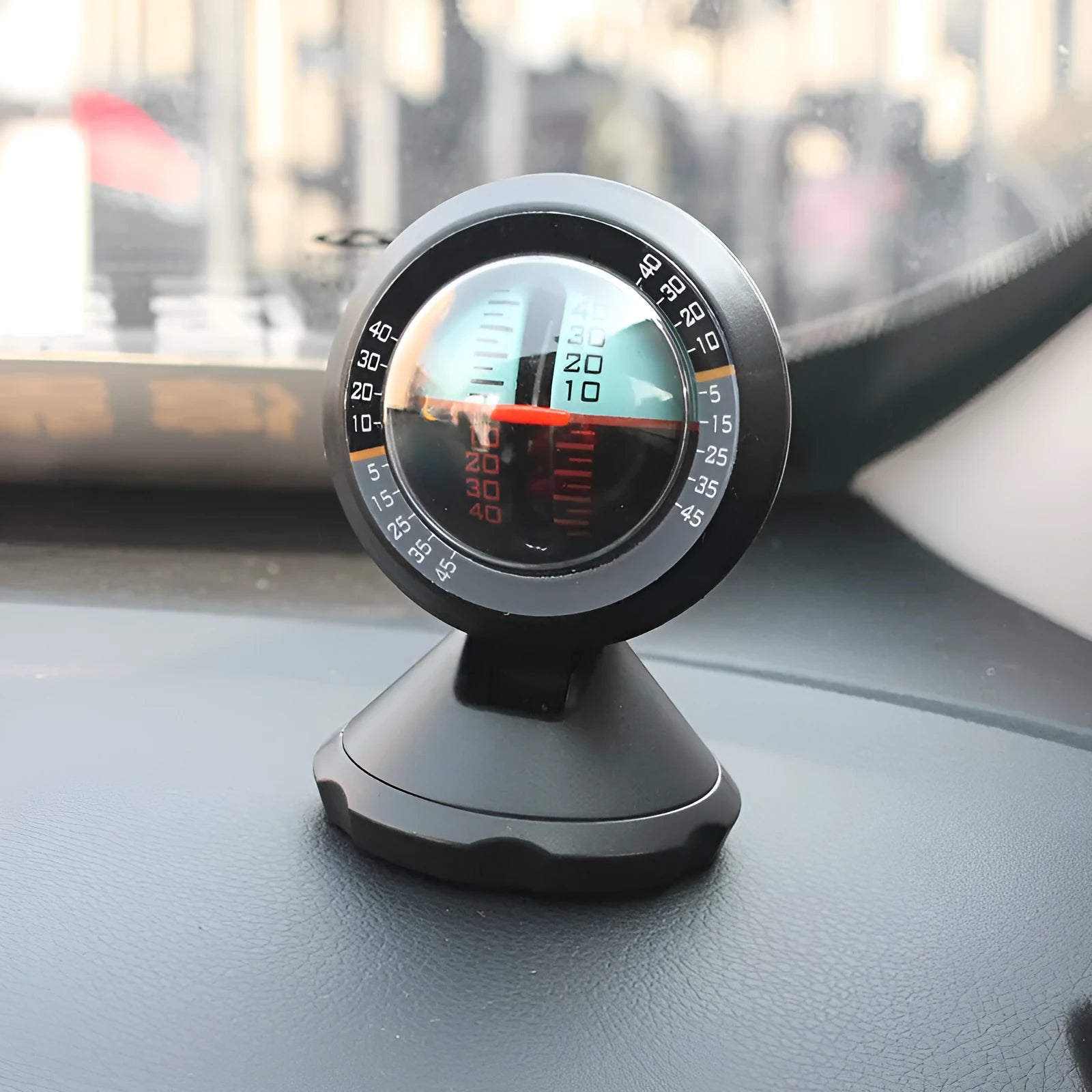 Black vehicle mounted slope meter for measuring inclination and rotation angles on dashboard.