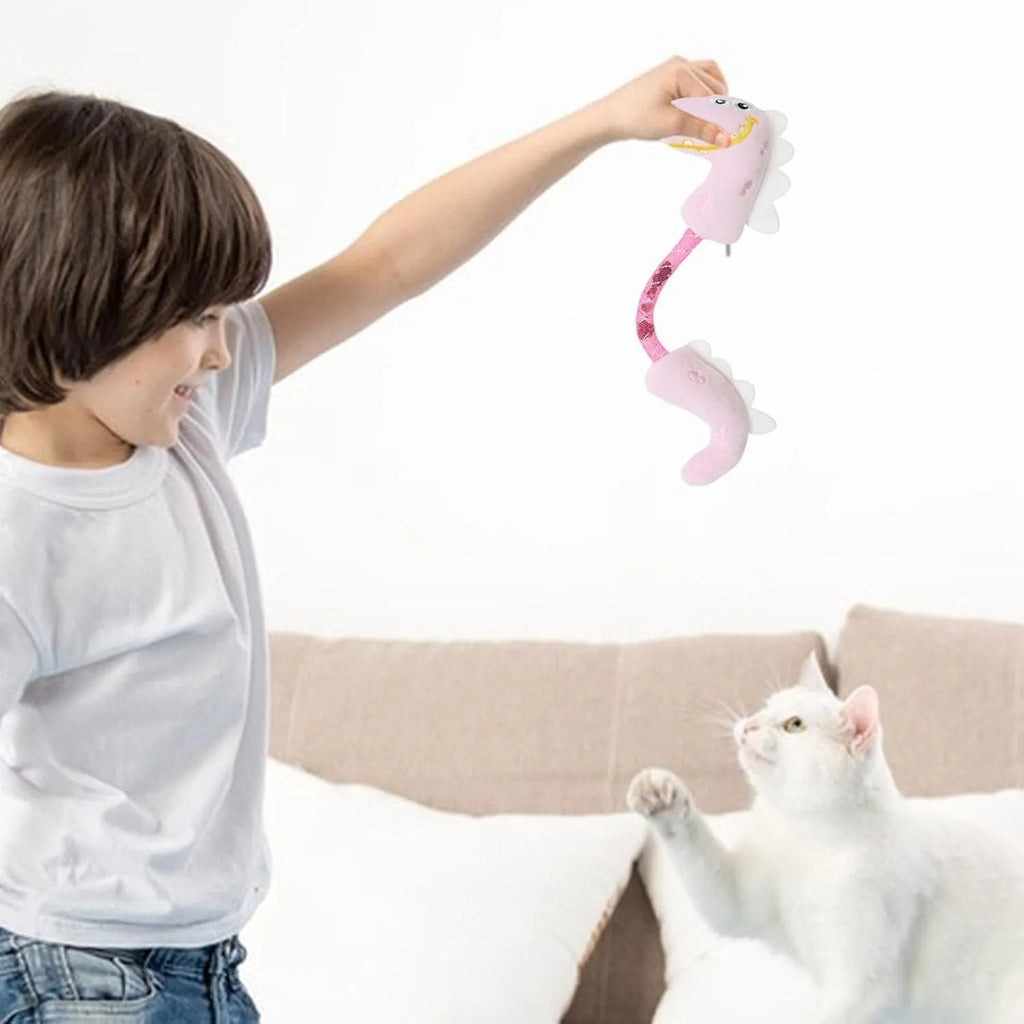 Set of four cat toys: plush chew toy, catnip rope, spring, and kicker toy on a pink background.