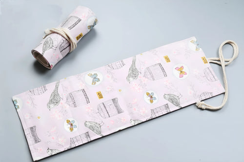 Rolled canvas pencil wrap with elastic bands holding coloured pencils, in 48-slot configuration