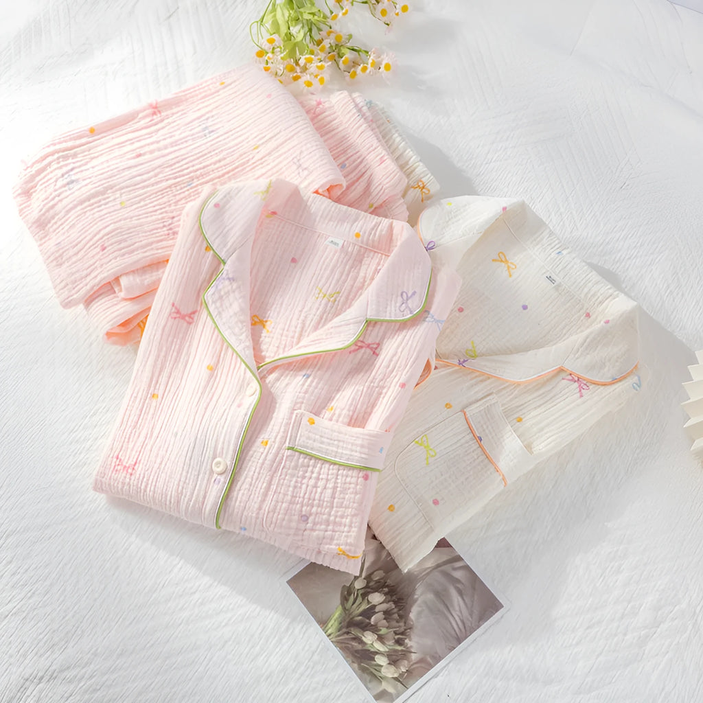 Women's beige cotton crepe pajama set with long sleeves and trousers on a hanger