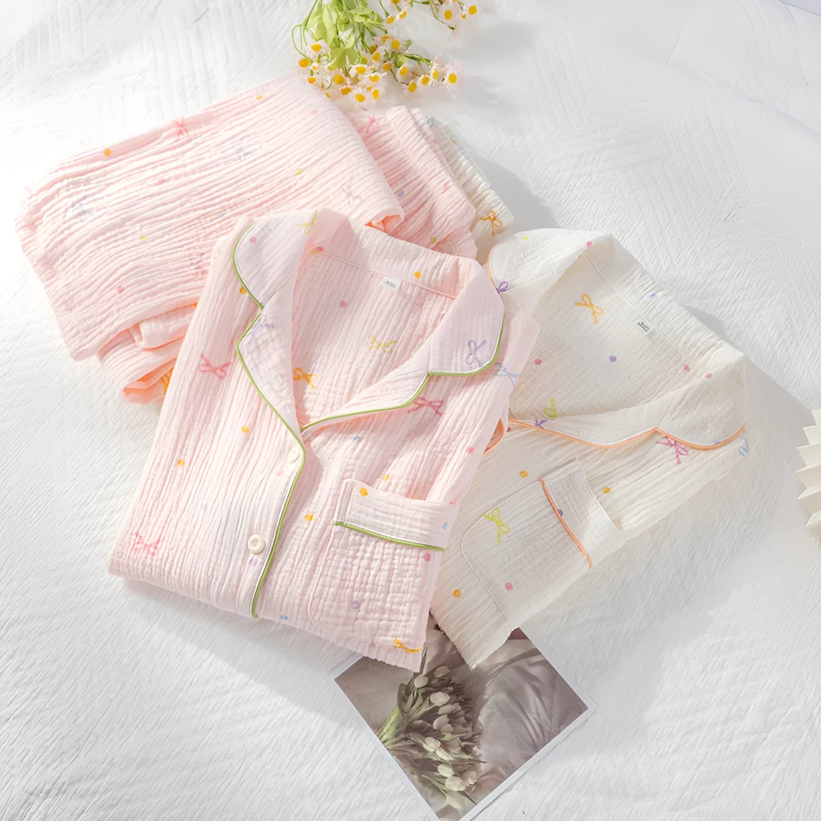 Women's beige cotton crepe pajama set with long sleeves and trousers on a hanger