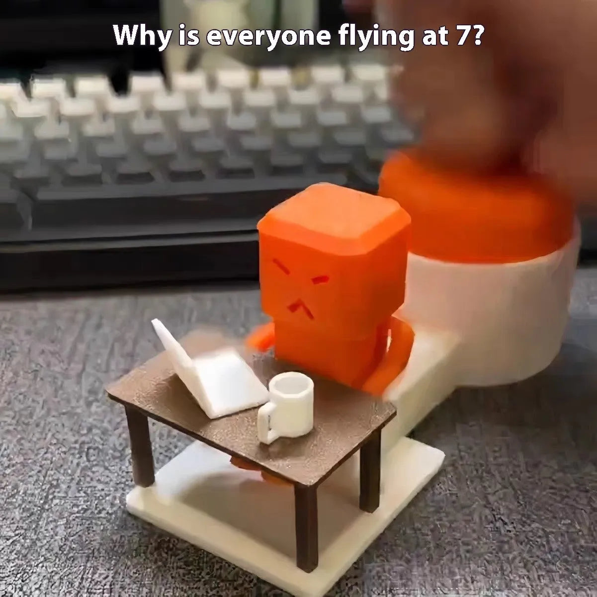 Orange plastic decompression toy with table-turning mechanism on flat surface