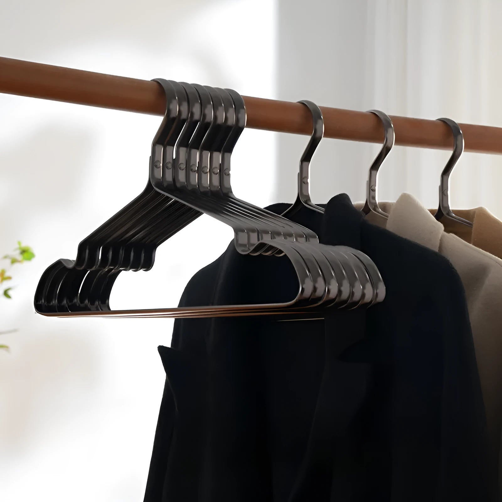 Elegant black non-slip metal clothes hanger for suits and trousers.