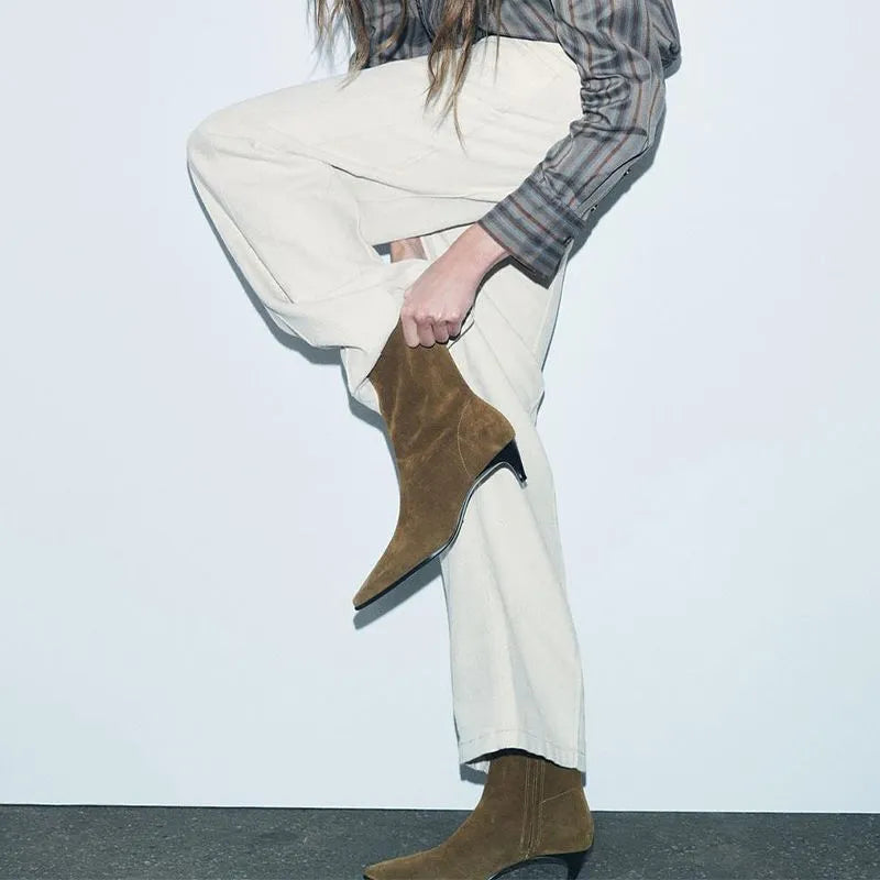 Brown square toe women's ankle boot with a side zip and a mid kitten heel on a plain background.