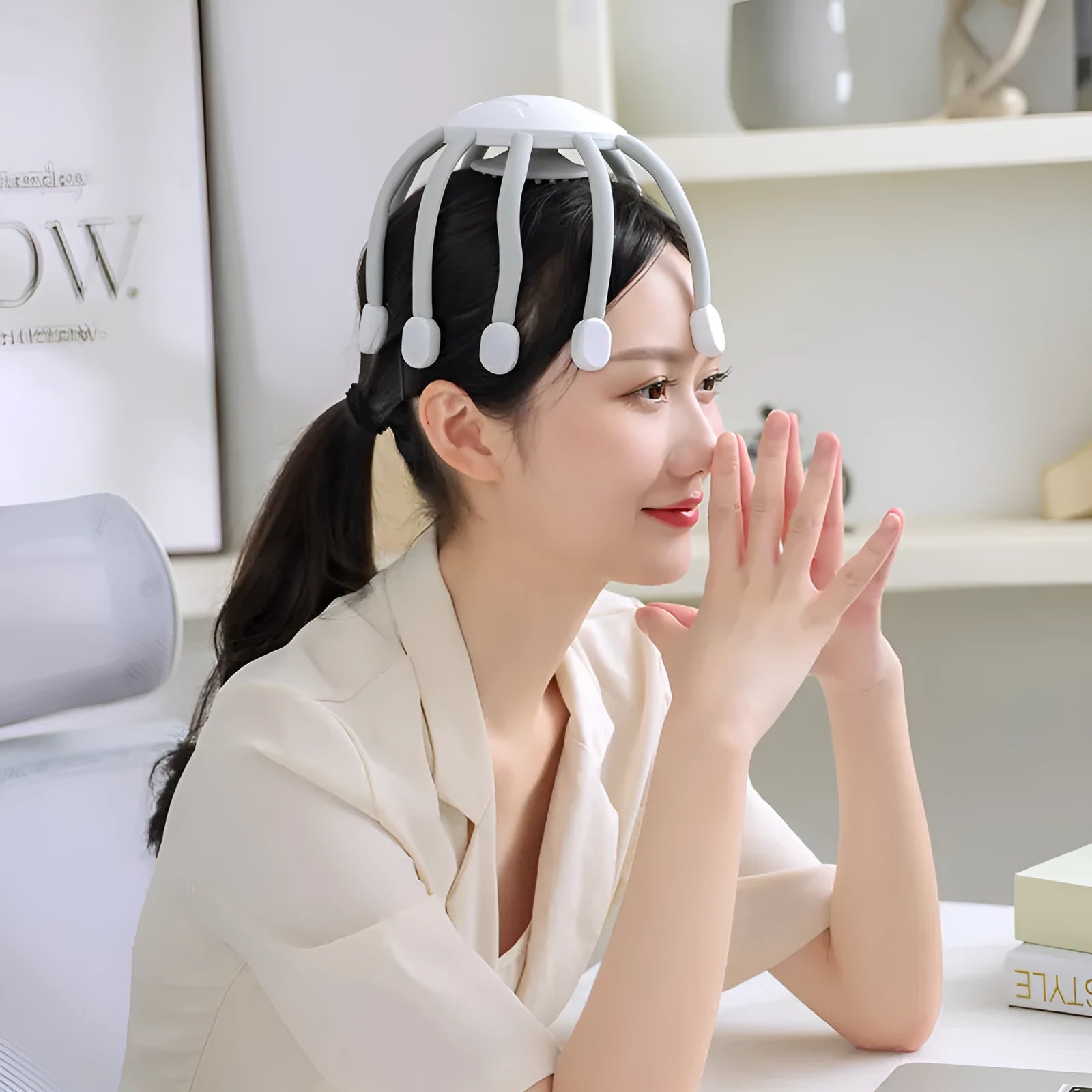 Black and white head massagers with multiple vibrating claws on a stand.
