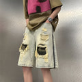 Men's yellow mud camouflage denim shorts with ripped detailing and straight leg cut