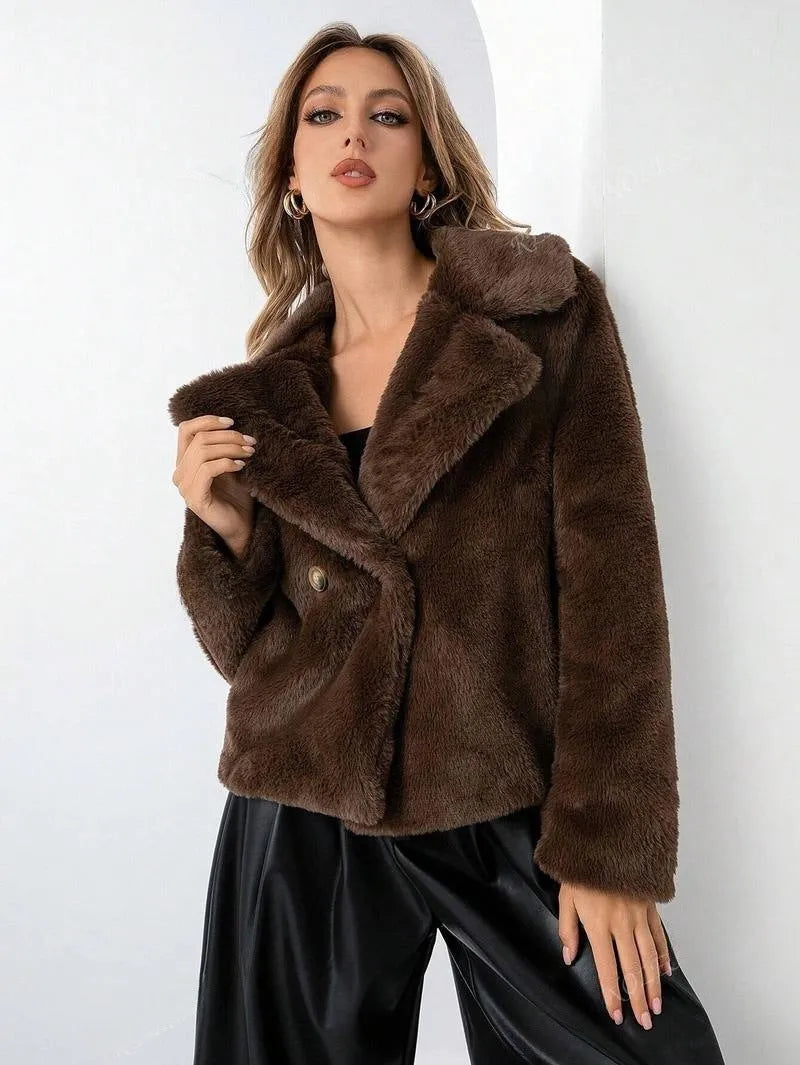 Women's short loose faux fur coat in rose red colour on a hanger.