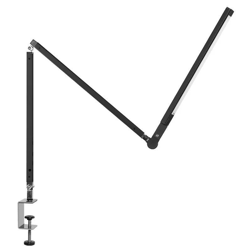 Adjustable LED desk lamp with clip attachment in black finish on wooden desk