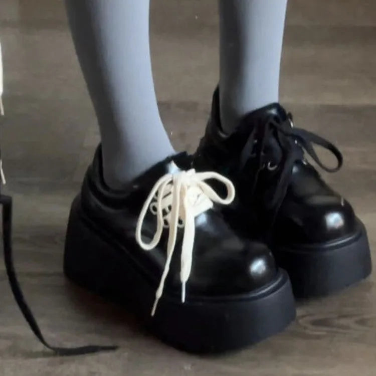 Matte black women's lace-up shoes with a chunky muffin heel and thick rubber sole