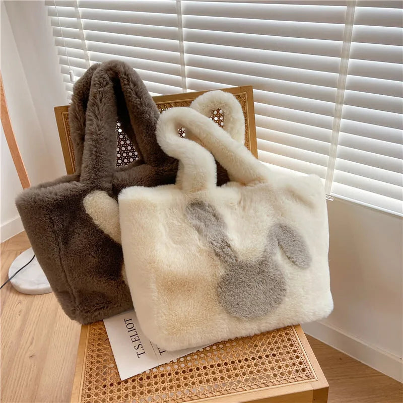 Cartoon rabbit ears plush shoulder tote bag in a solid colour on a model.