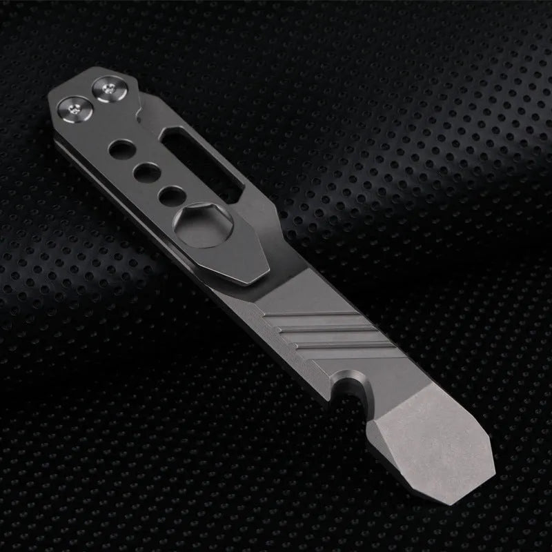 Titanium alloy multi-tool with crowbar edge, screwdriver tip, and bottle opener notches on a stone wash finish background.