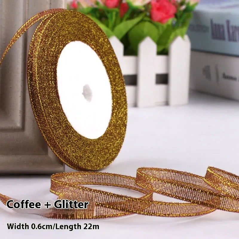 Roll of narrow 0.6cm wide polyester gift ribbon in a multicolour pattern.