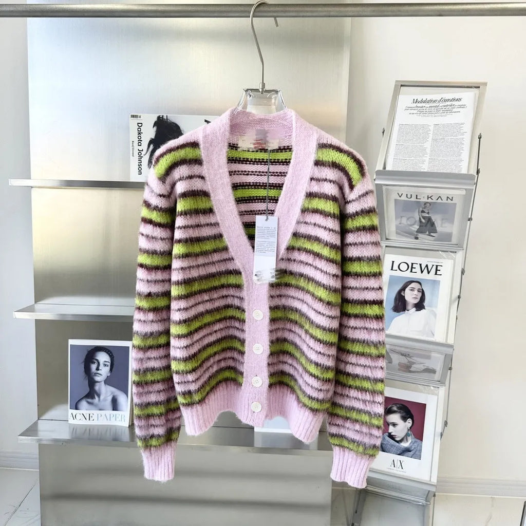 Pink lazy coat style wool blend cardigan with contrast colour detailing on a hanger.