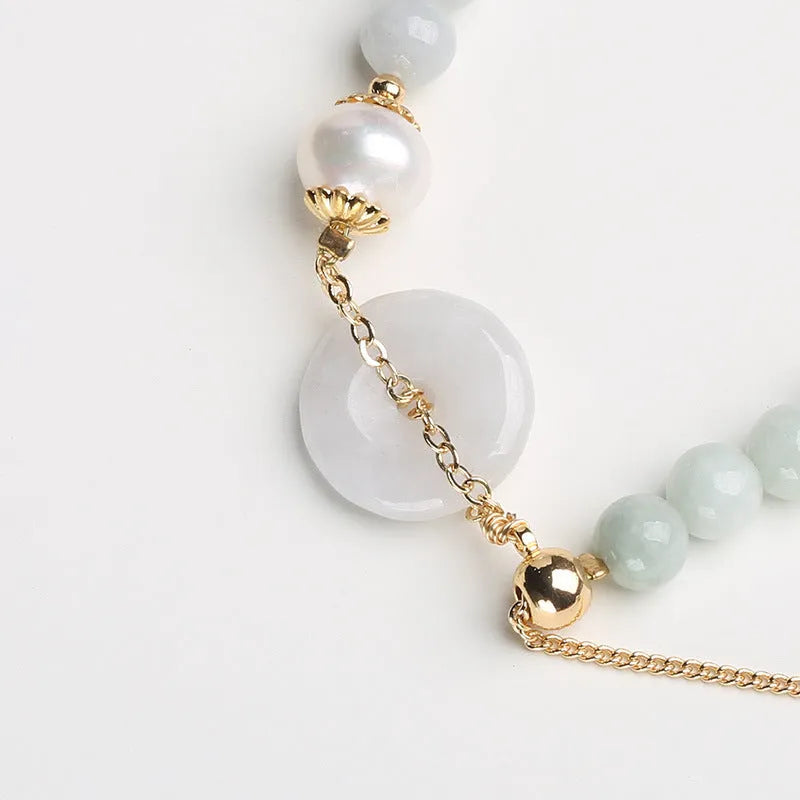 Natural emerald green jade bracelet with pearl accents and peace symbol buckle clasp