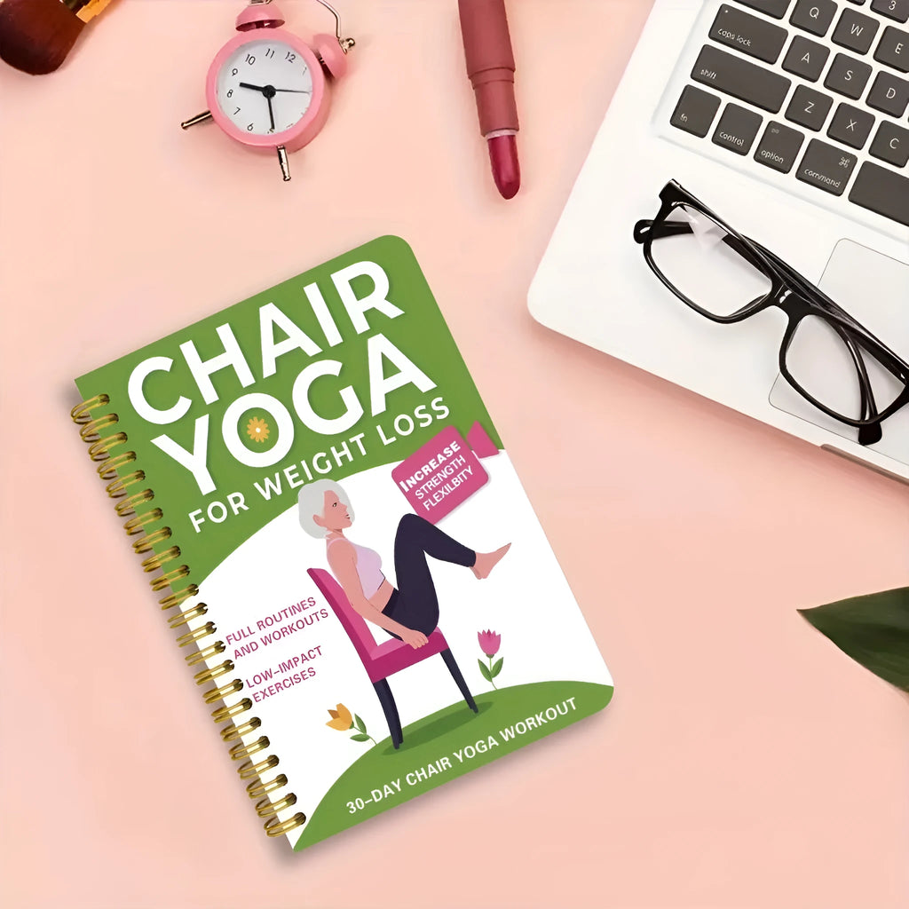 Green coil-bound 30 Days Chair Yoga Training Guide notebook lying open.