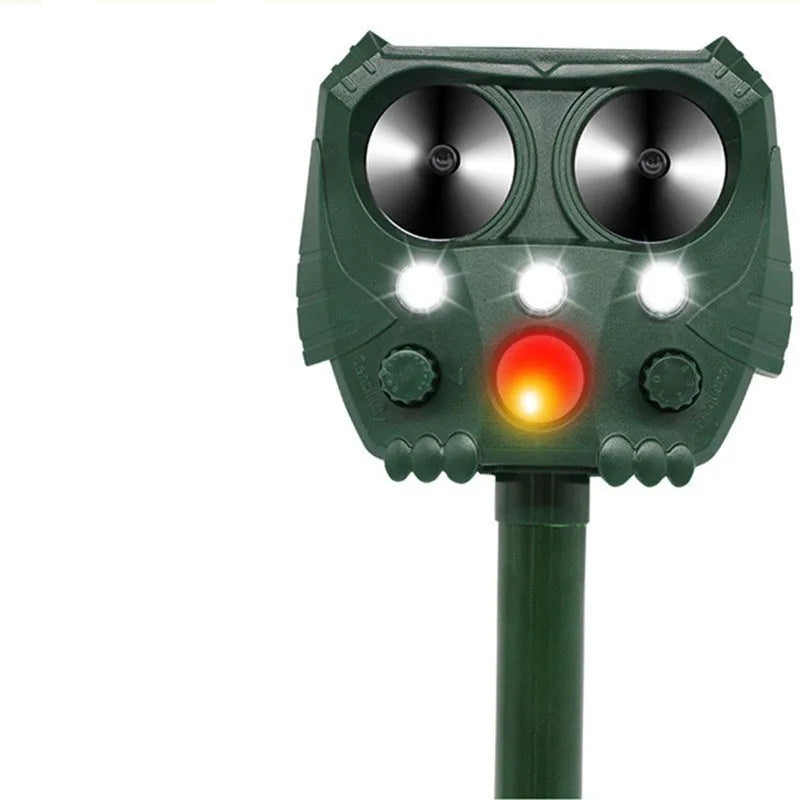 Green solar-powered ultrasonic animal repeller unit for outdoor pest and dog control.