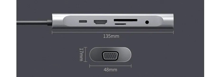 Grey aluminium USB-C docking station with HDMI, VGA, USB 3.0, and PD charge ports on a desk.