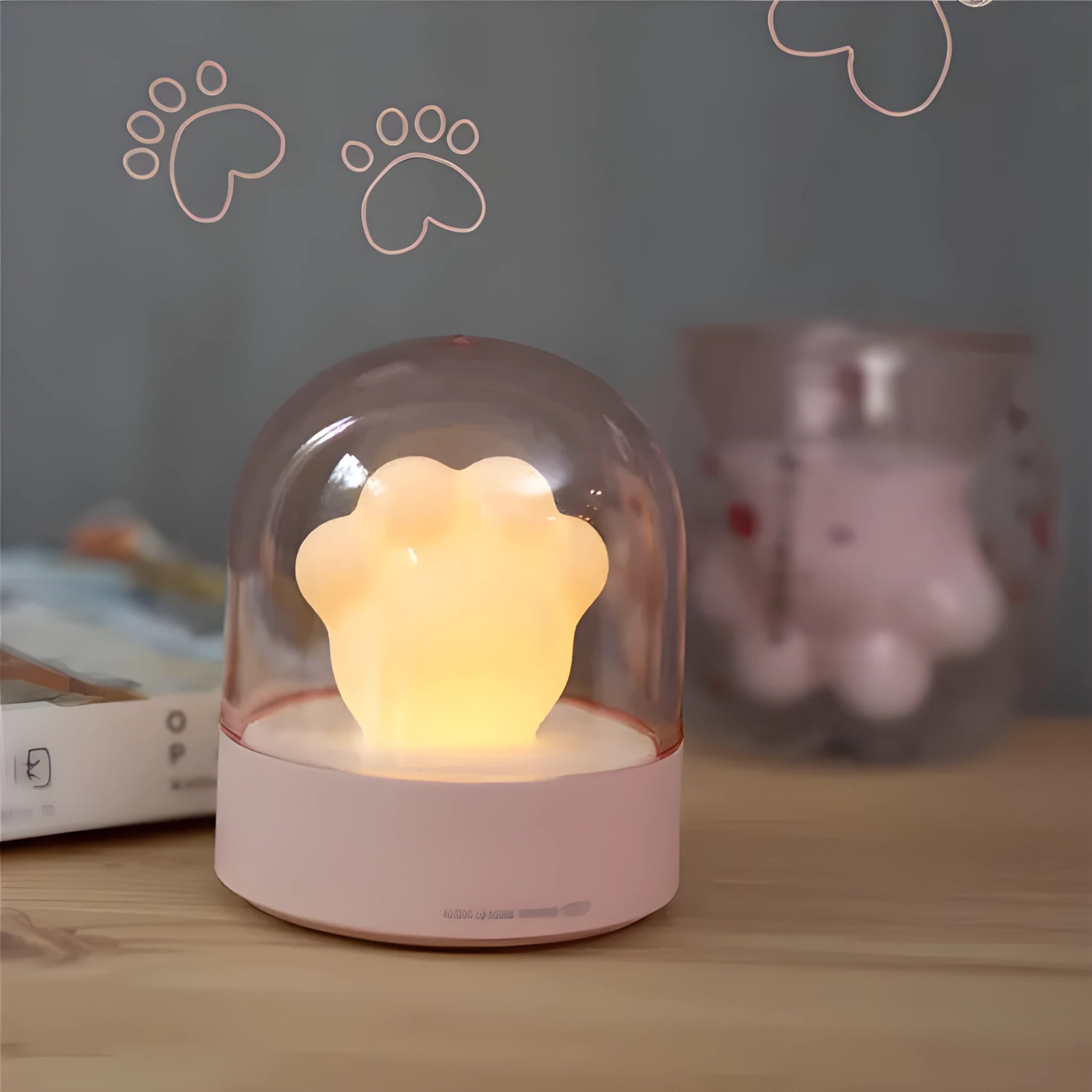 Grey and pink cat paw shaped USB rechargeable night light with rotating dynamic lighting