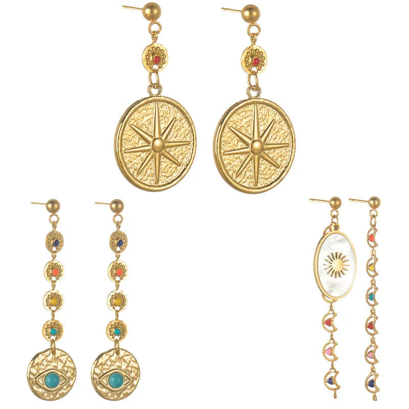 Set of three geometric earring pairs: stainless steel star, eye, and shell sun designs.