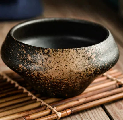 Tall porcelain ceramic Japanese soup bowl with underglaze vintage pattern on wooden table.