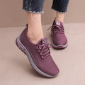 Women's black mesh sneakers with cross-strap detail and round toe on a rubber sole.