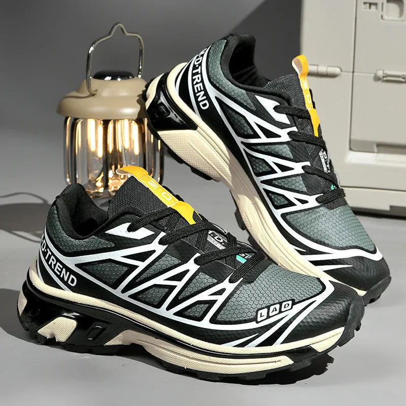Pair of low-top hiking shoes in artificial leather with a mesh lining and rubber sole.
