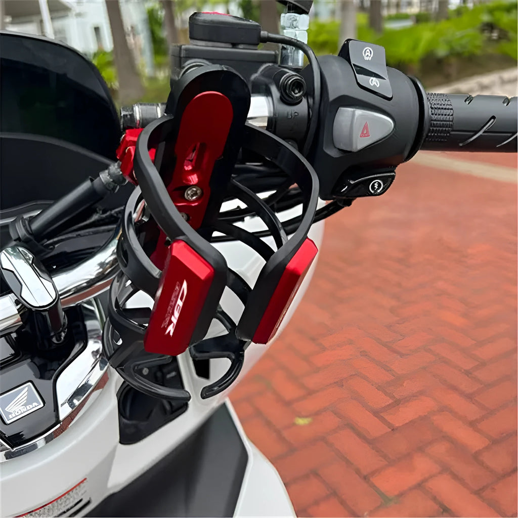 Black water bottle cage mounted on a Honda X-ADV scooter.