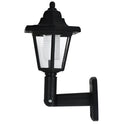 Black hexagonal solar-powered wall light with LED and solar panel for outdoor use