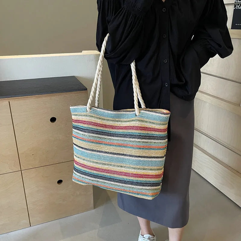 Blue woven nylon shoulder bag with straw-weave pattern and adjustable strap