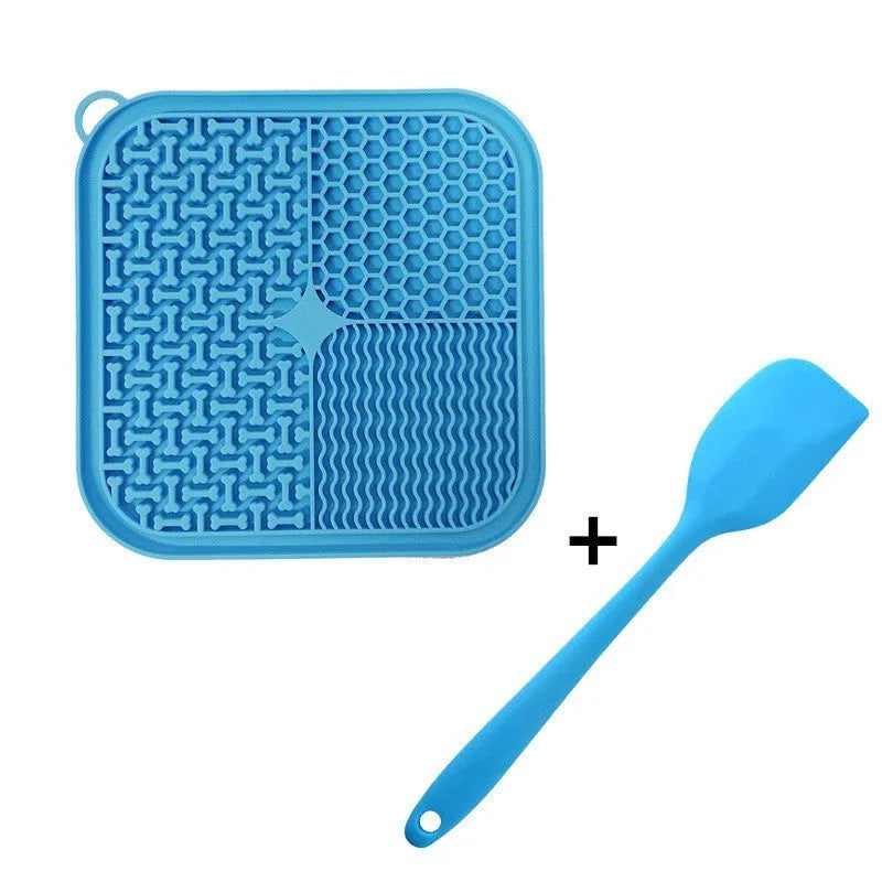Blue silicone dog licking mat with textured surface and suction cups on a clean floor.