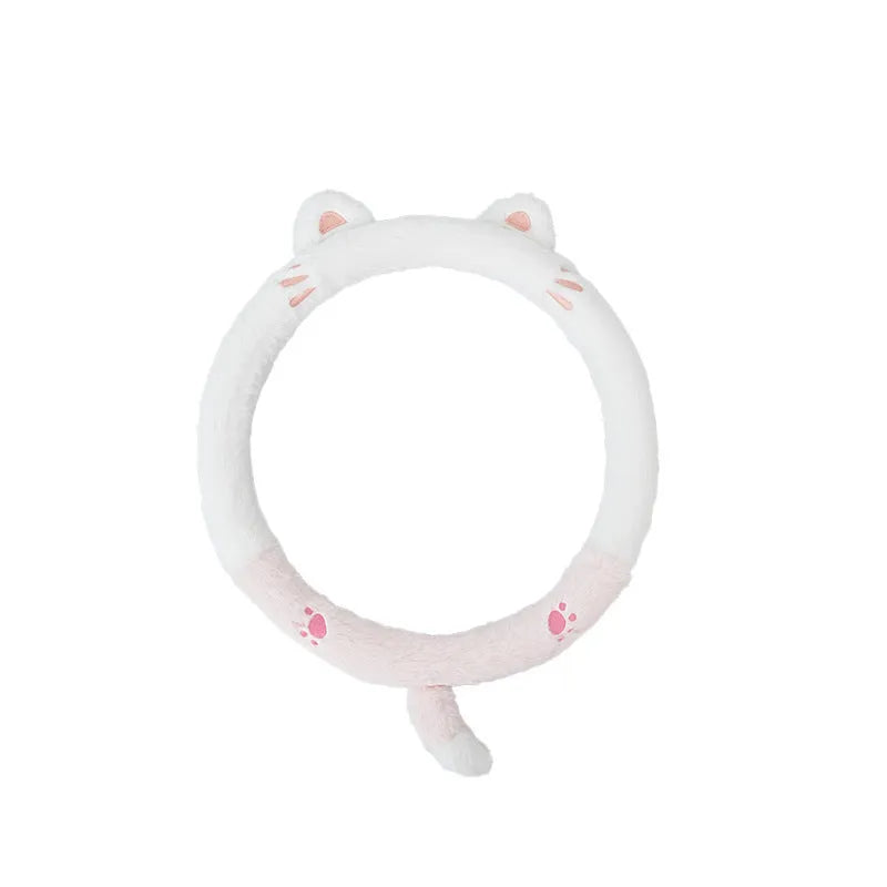 Plush steering wheel cover with embroidered bear design, shown fitted on a car steering wheel.