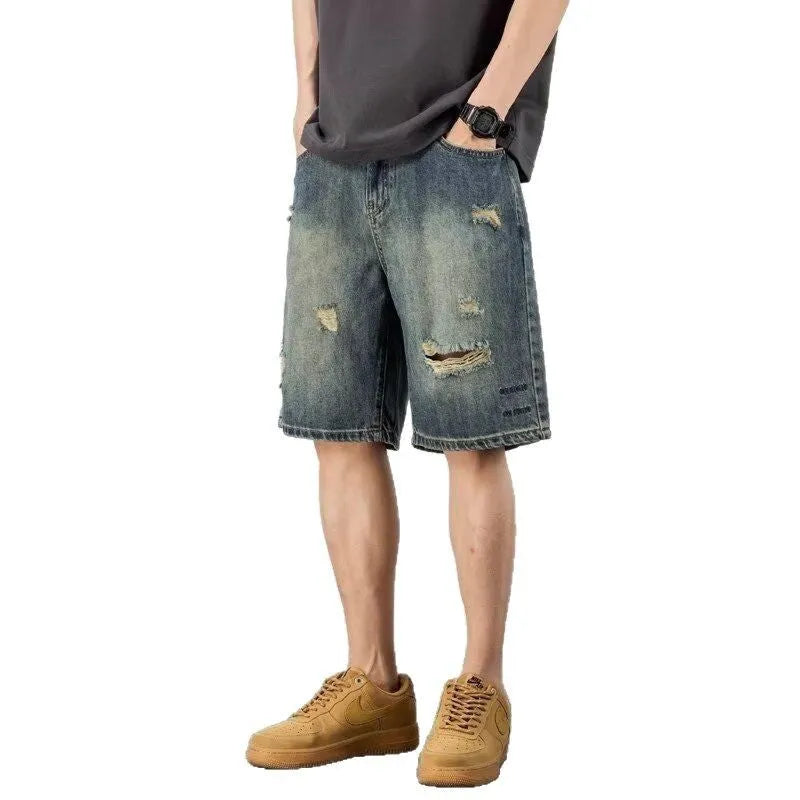 Blue retro loose-fit men's denim shorts with distressed holes and a straight-leg cut