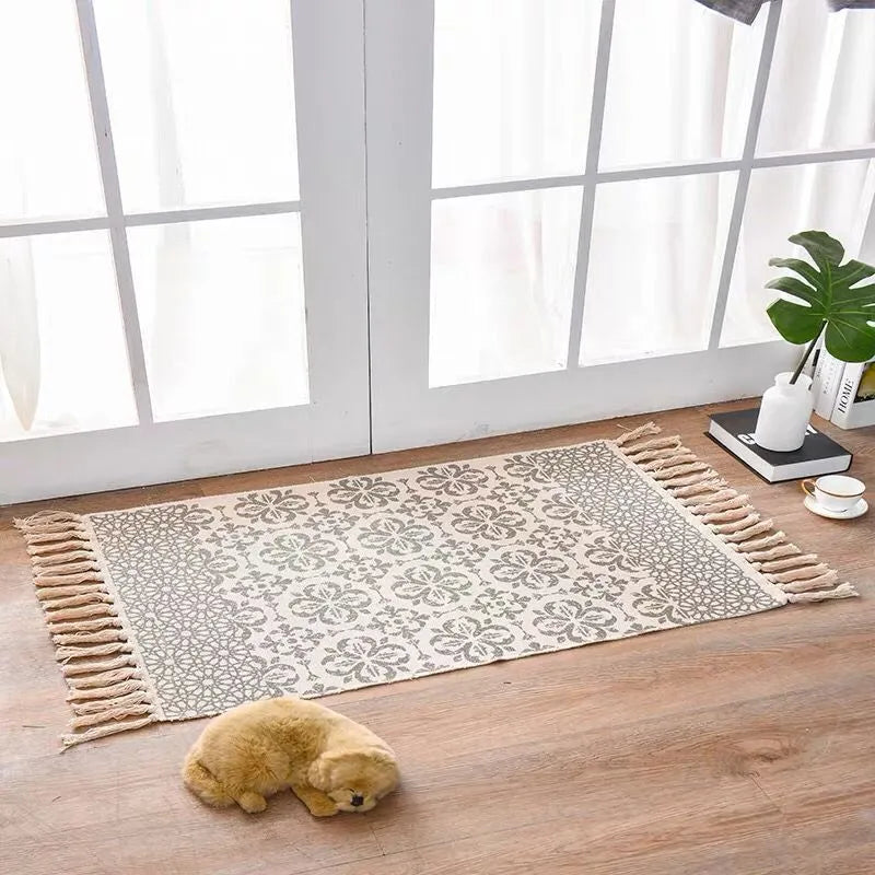 Handwoven cotton linen floor mat 60x90cm in ethnic style with natural plant dye, placed on a wooden floor