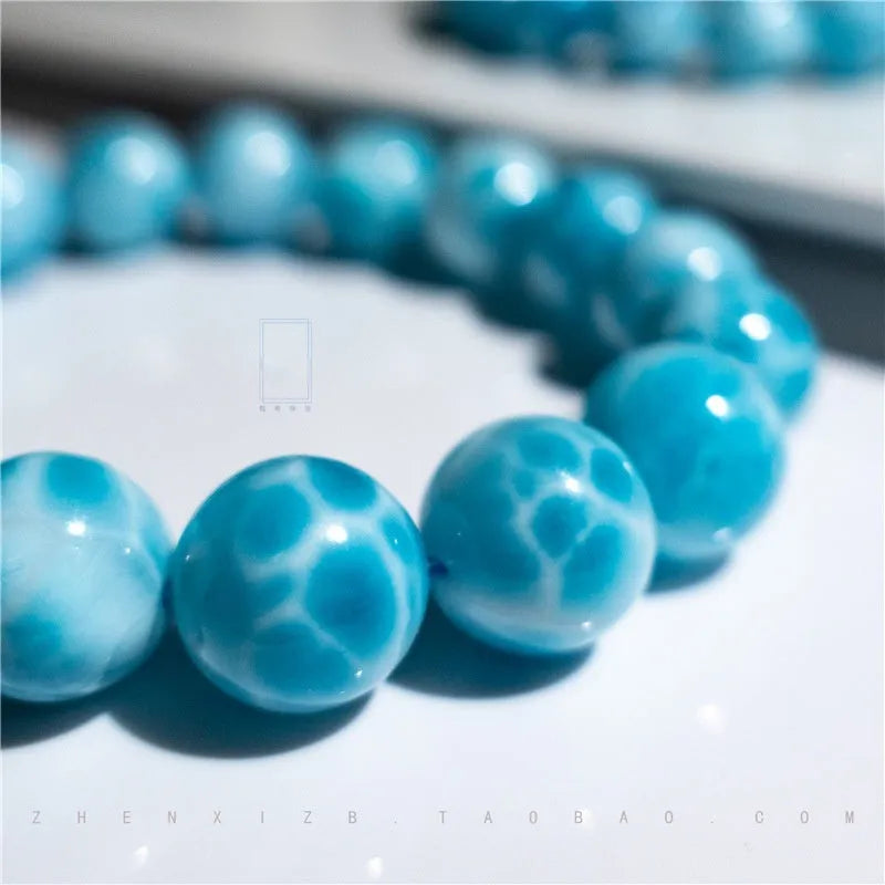 Blue handmade Bodhi bracelet with natural crystal, sea-pattern stone, and pearl in Maillard style.