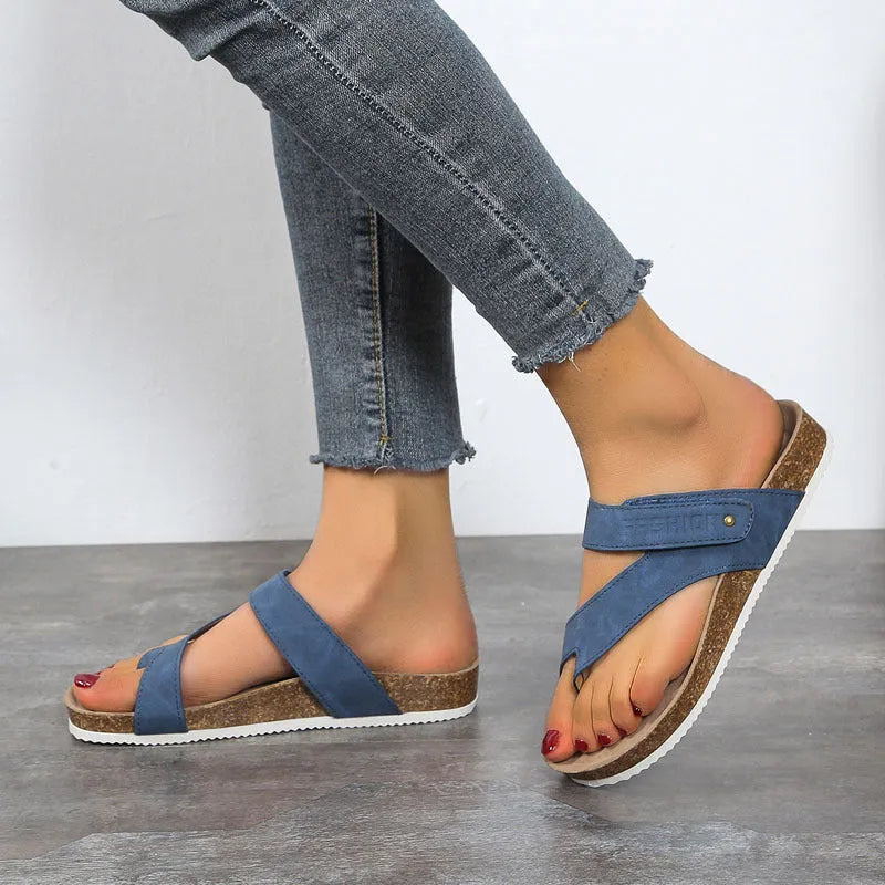 Blue thick-soled flat toe ring flip-flops on a white background.
