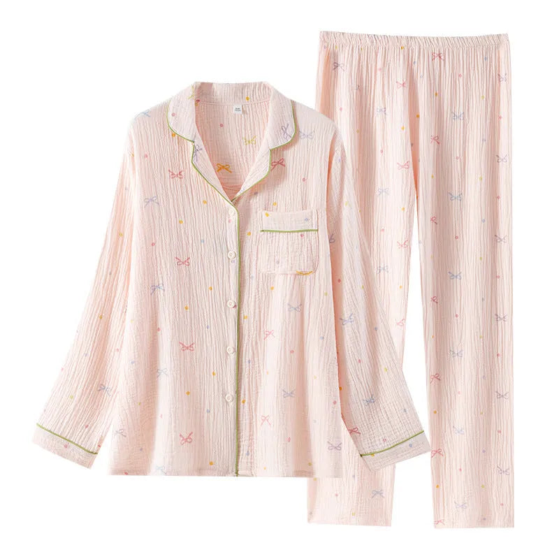 Women's beige cotton crepe pajama set with long sleeves and trousers on a hanger